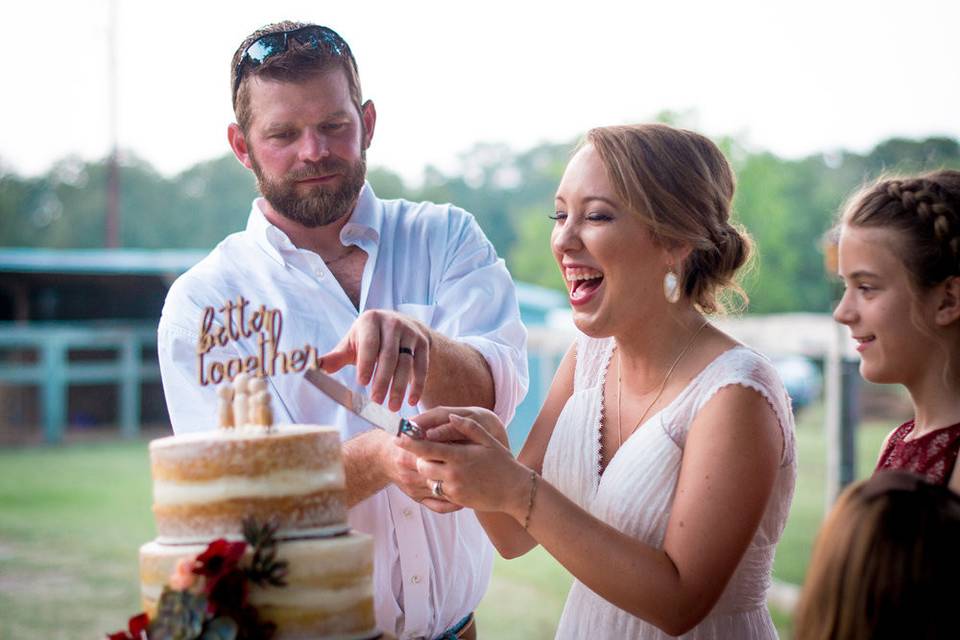 Newlyweds slicing cake