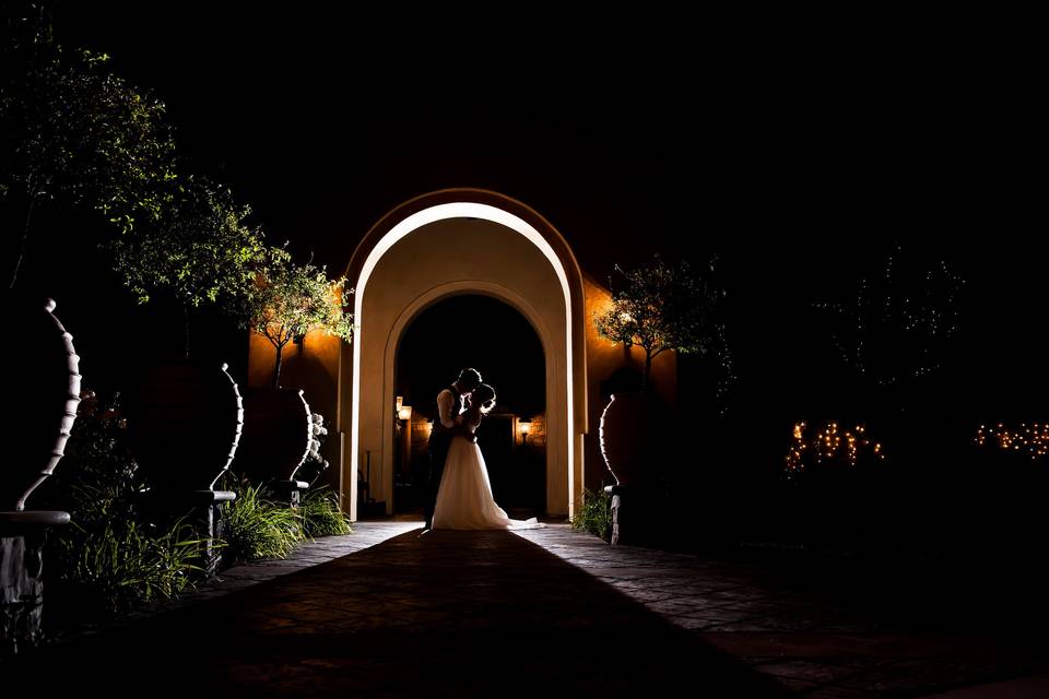 Couple under an archway at night