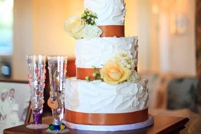 White textured cake with brown ribbon band