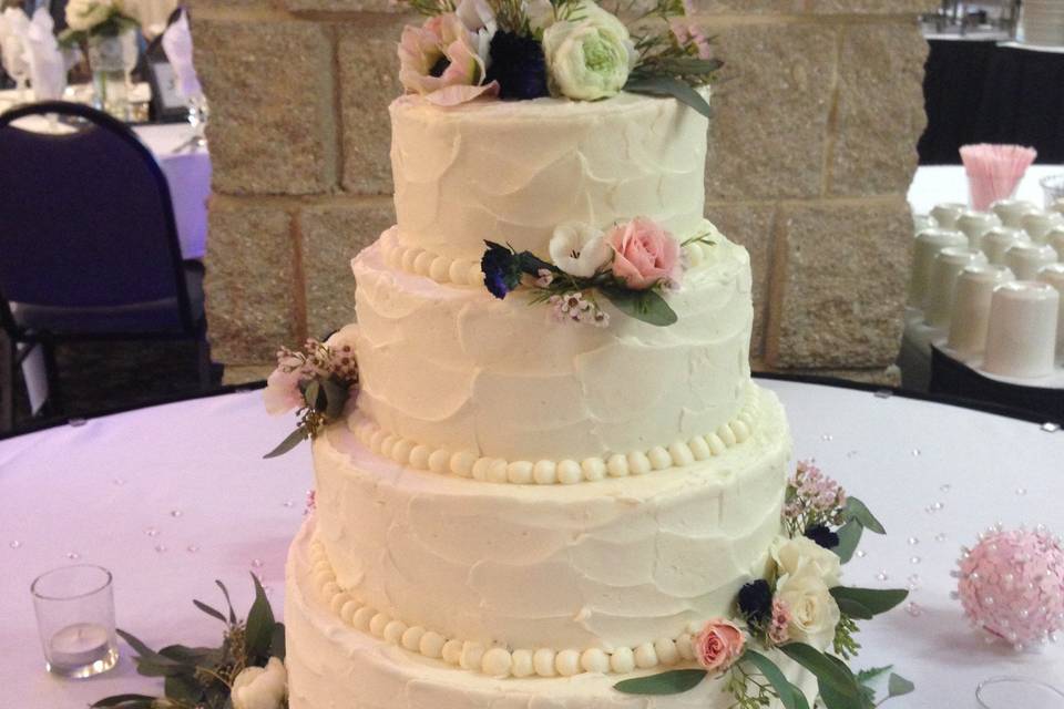 Four tier wedding cake with flowers