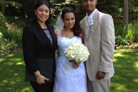 Post-ceremony photo of the newlyweds and officiant