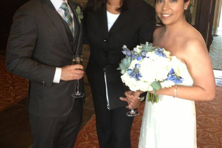 Groom and bride with their officiant