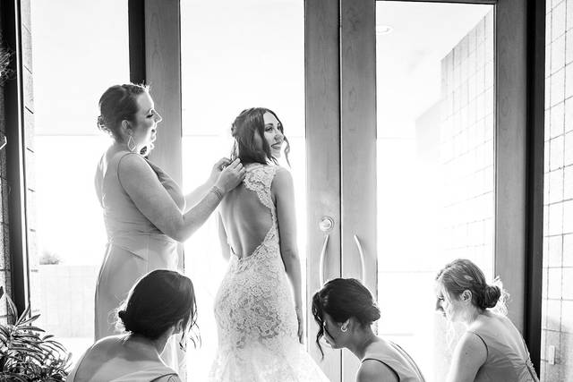 Bridesmaids preparing bride