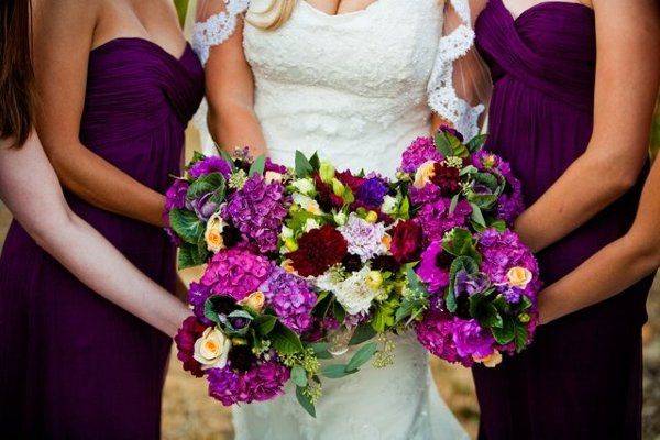 The bride with her bridesmaids holding a bouquet