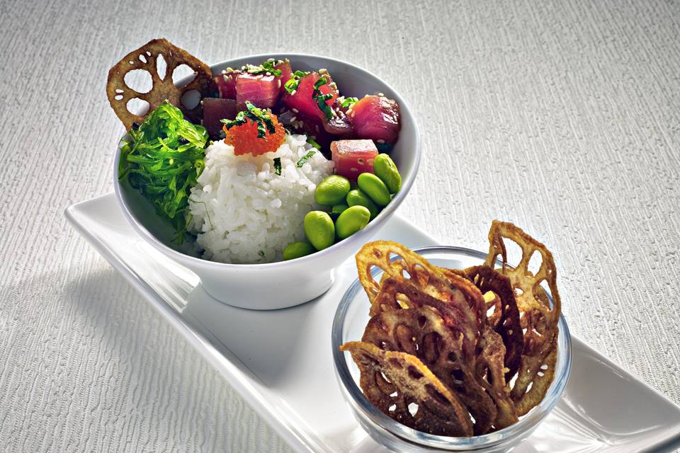 Our famous poke bowl: Ahi tuna with wasabi creme fraiche, edamame, wakame salad, tobiko and crispy lotus chips.