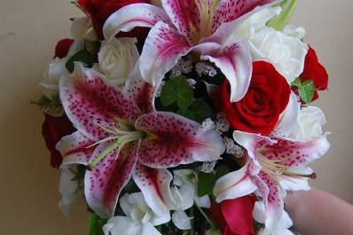 Stargazer lilies, red and white roses, white dendrobium orchids