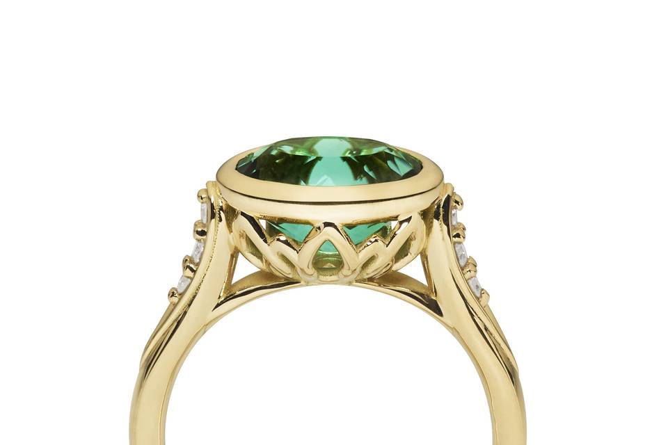 One of our newest designs, the Concerto Ring was inspired by the 50th Anniversary of our business. A joyful green tourmaline set in 18k yellow gold is the star of this celebratory piece with brilliant cut bead set diamonds supporting its beauty. Hidden among the decorative setting is a yellow sapphire, placed in recognition of our “Golden Anniversary.” Contact us for “one of a kind” possibilities. #160409