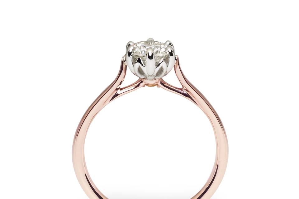 Our 50th Anniversary is truly a Jublilee, and we designed a diamond ring to capture the excitement. A .73 carat diamond nestles in a six prong platinum cathedral setting. Its beauty is highlighted by a graceful 14k rose gold band. We didn’t forget to set a special golden sapphire on the underside of the diamond, as a nod to our “Golden Anniversary” and a hidden treasure for you. Contact us to discuss “one of a kind” possibilities. #030511