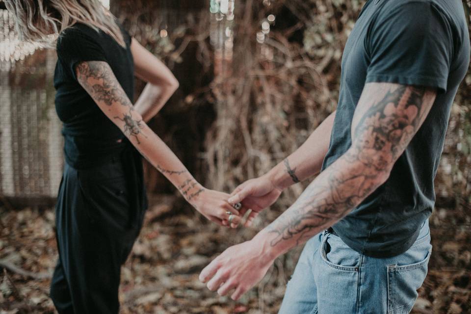 Tattooed couple holding hands