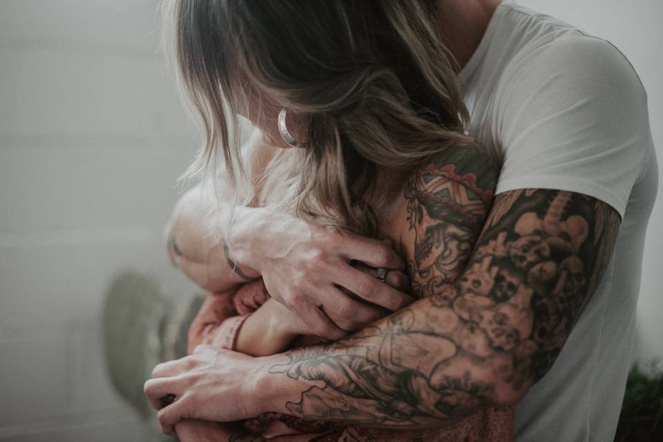 Tattooed couple hugging