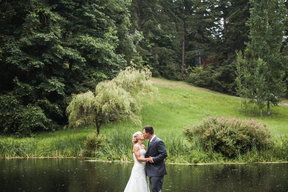 Bride and groom by lake