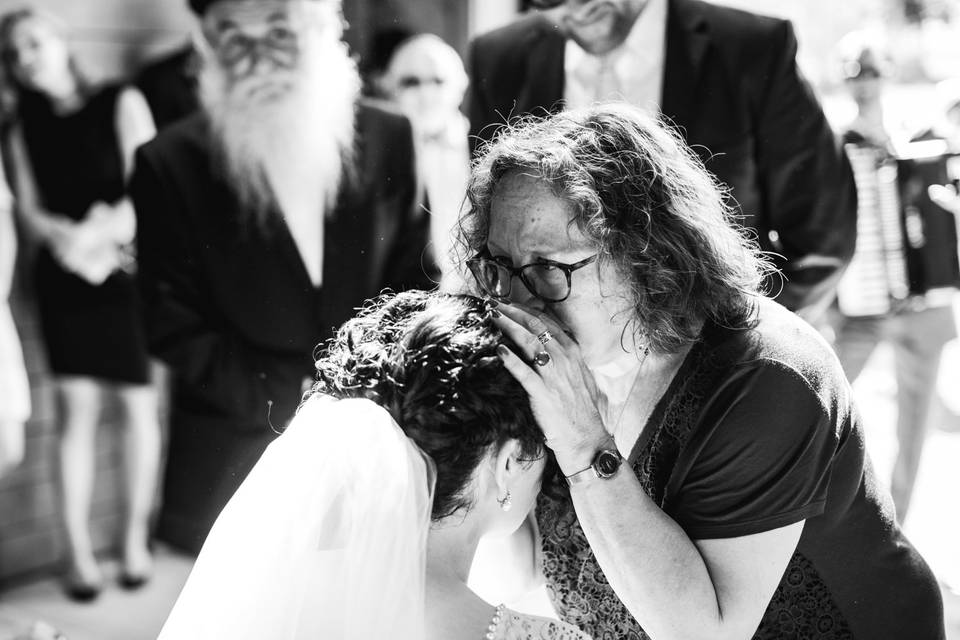 Mom kissing daughter