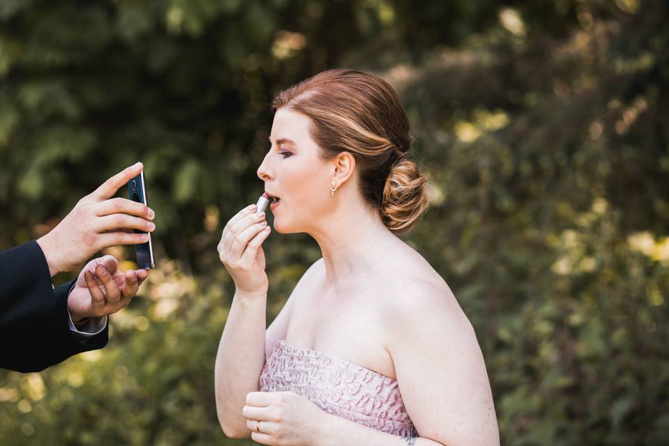 Bride putting on lipstick
