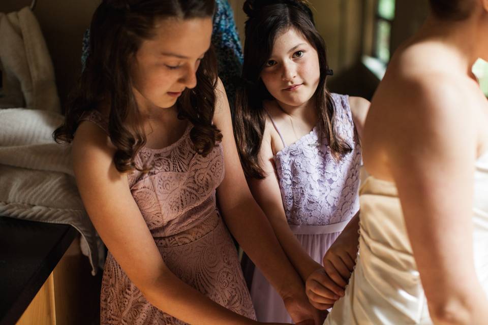 Daughters helping bride