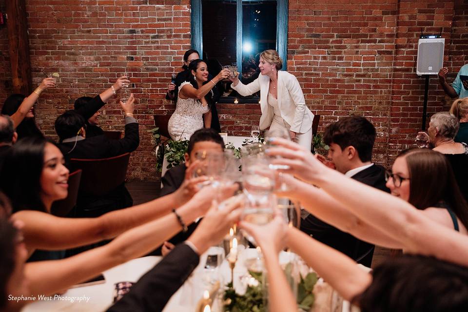 Hands cheer glasses together