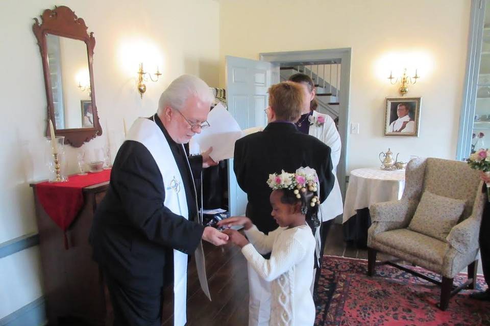 The flower girl with the wedding officiant