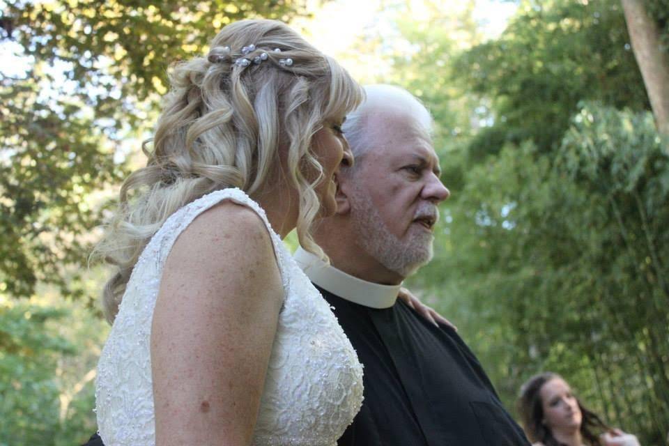 The newlyweds with the wedding officiant