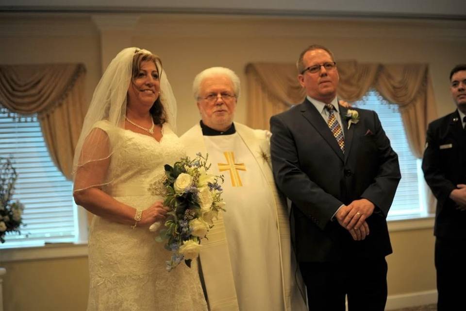 The newlyweds with the wedding officiant