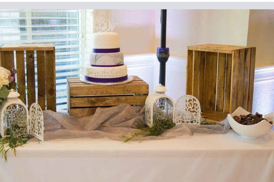 Marbled fondant gives an abstract view. Adorned with purple ribbon.