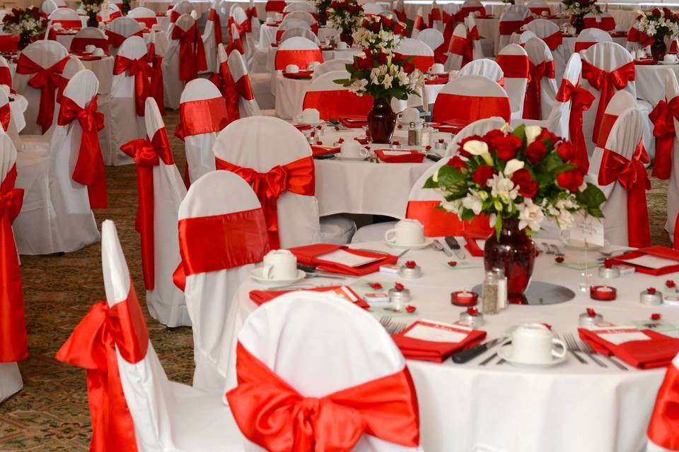 A beautiful red and white, romantic wedding in our Sawtelle Room. White chair covers with red sashes, mirrors, candles and fresh flowers