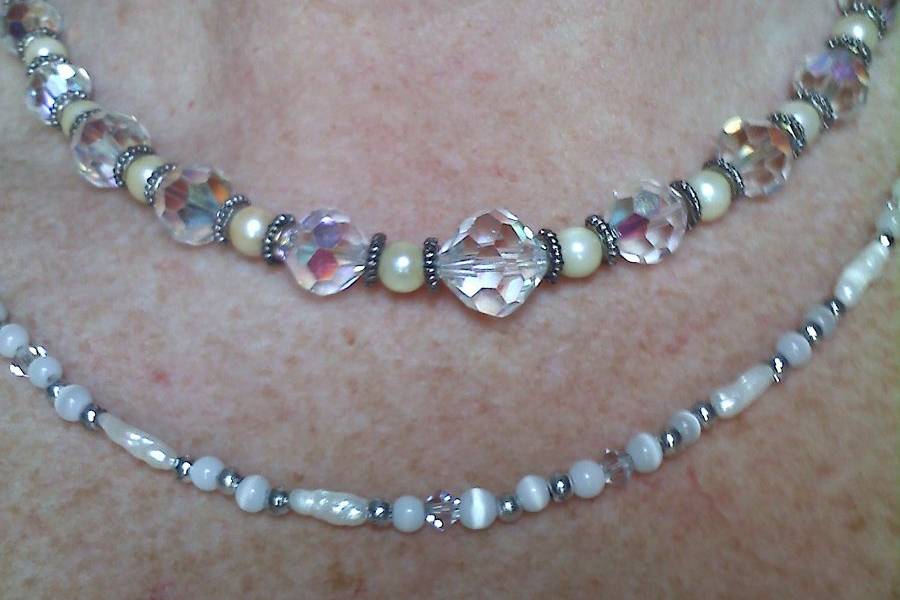 This necklace is made of clear and AB crystals, with real cultured pearls and silver spacers, the bottom layer is mother of pearl, fresh water pearls, and white cats eye. I did take this necklace apart and made 2 seprate necklaces, but can make another like it.