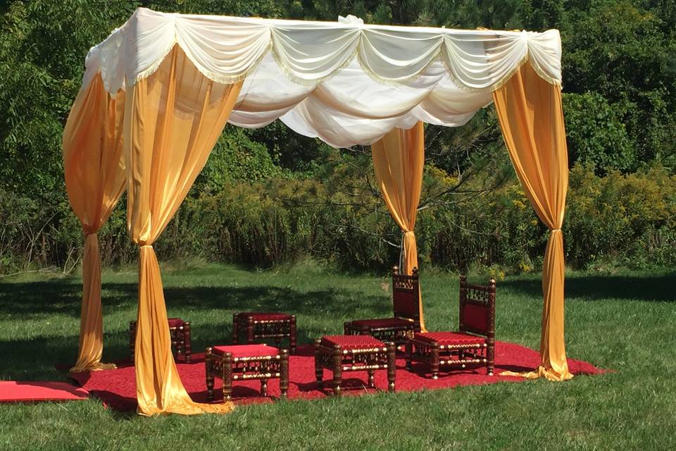 Gold, Red, & Ivory Mandap. Mandap furniture rental also available with red carpet.