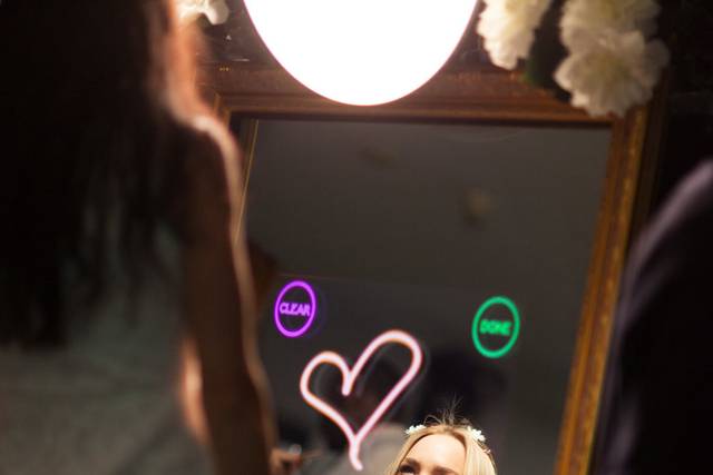 A bride signing her creation on the Mirror Me Booth