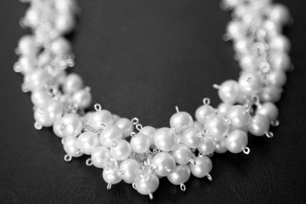 This stunning necklace was handmade with over one hundred freshwater pearls clustered with genuine swarovski crystals on a sterling silver chain. It is a perfect balance of classic elegance and modern flair. The crystals can be customized to coordinate with any color scheme.
After the wedding, send the necklace back to me and I'll redesign it into a bracelet free of charge. It will be the one thing from your wedding day that you can wear again and again!
www.etsy.com/shop/jomariejewelry
