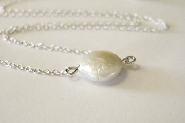 A gorgeous little freshwater coin pearl seemingly floats on the delicate sterling silver chain. This necklace is beautiful in its simplicity and looks great on its own or layered with my Turquoise and Pearls - Necklace. It is also a wonderful companion piece to my Coin Pearl Earrings.
* 9 mm Freshwater Coin Pearl
* 15