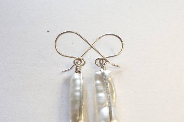 Unique and elegant, these earrings are made with freshwater stick pearls wrapped in hammered sterling silver. The perfect complement to my Delicate Coin Pearl Necklace. (Available in gold)
* Sterling silver hand crafted earring hooks
* Hang approximately ¾