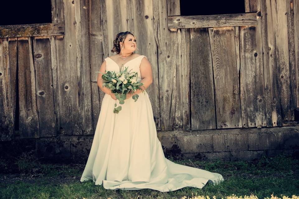 Bride next to barn