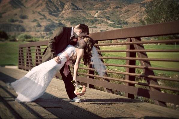 The rustic bridge is the perfect backdrop for the bridal couple