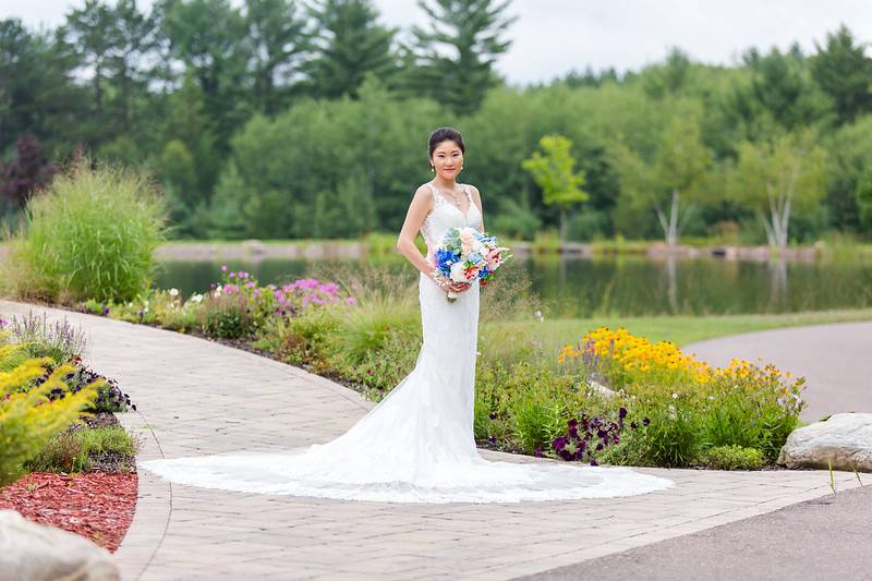 Bride on lakeside walkway