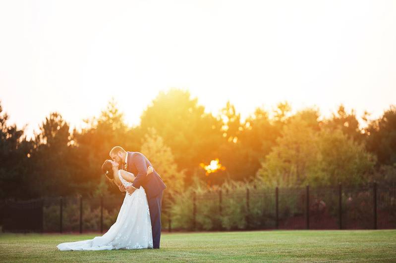Newlyweds share kiss at sunset