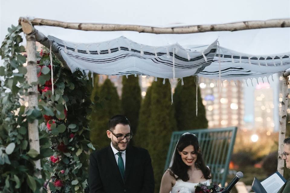 Couple and child under chuppah