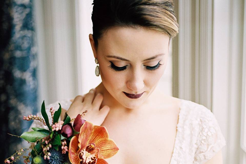 Bride putting earrings on