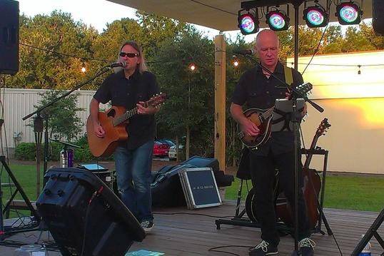 Dos Eddies Acoustic Duo performing on the outside stage at Ogden Tap Room in Wilmington, NC.