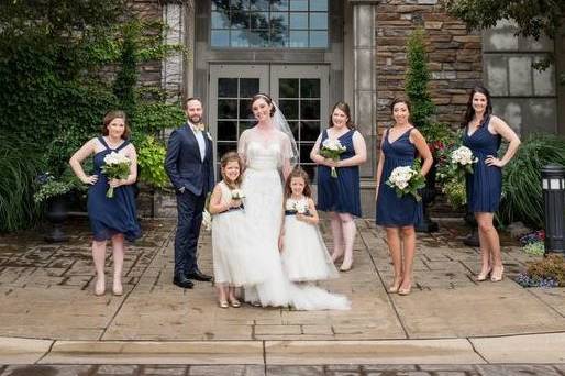The couple and bridesmaids and flower girl