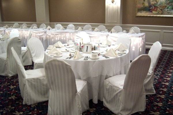 A white & ivory themed wedding with ivory striped chair covers in October 2008.