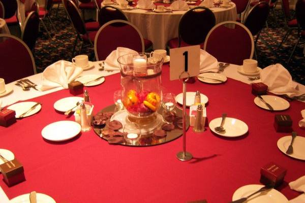 Mirrors, votives, number stands, and place settings come courtesy of the Holiday Inn Downtown.