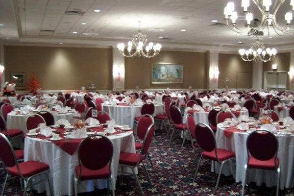 The reds and oranges of this fall-themed October 2008 wedding for over 200 guests are set off by the coordinating burgundy Holiday Inn Downtown chairs.