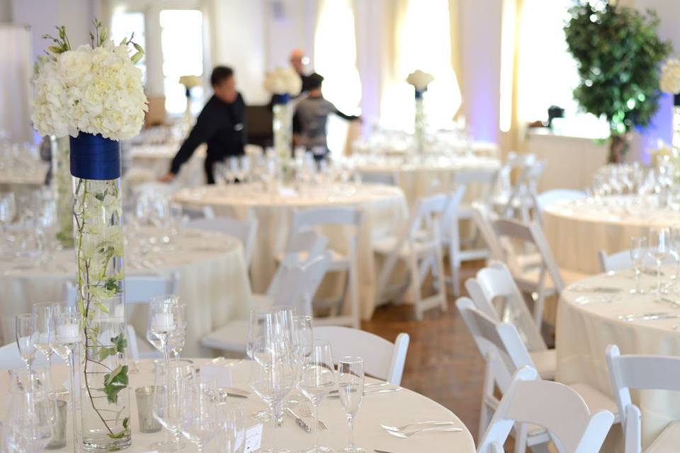Pure Glassware, White Folding Chairs and pops of blue complete the look of this wedding at Midtown Loft and Terrace catered by Barraud Caterers