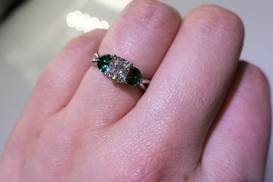 cushion cut with emerald split shank engagement ring