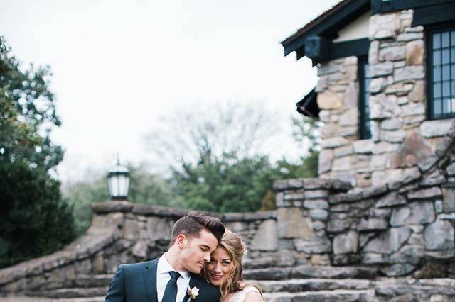 Newlyweds posing with fresh bouquet