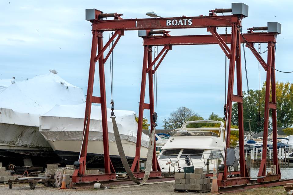 A red steel boat hoist over sh