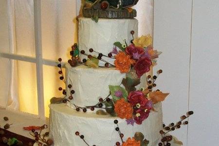 4 buttercream textured tiers adorned with hand made sugar flowers and berries.