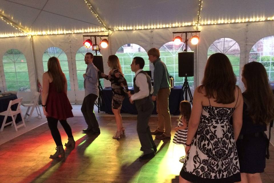 smaller crowd line dancing at tent set up on the ground of Felt Mansion in Saugatuck, MI