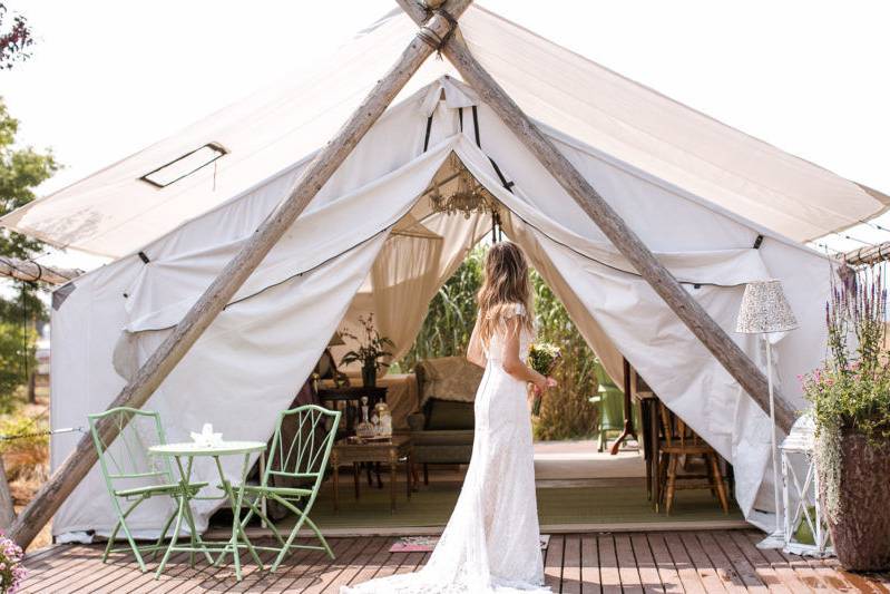 Bride poses with Glamping Tent