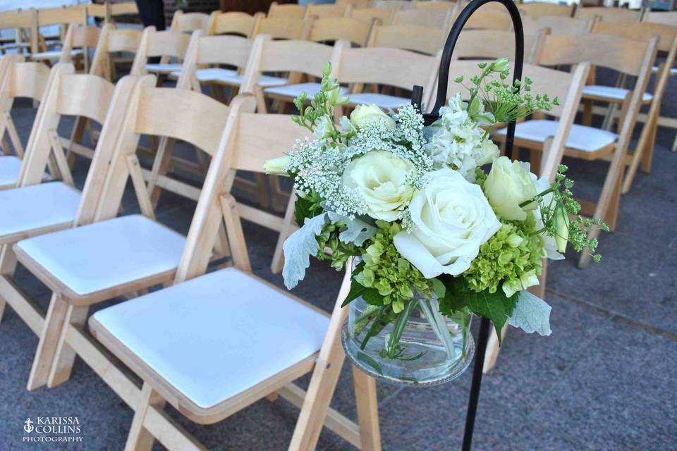 Shepherd's hook with summer flowers for ceremony aisle