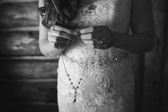 Bride putting on jewelry